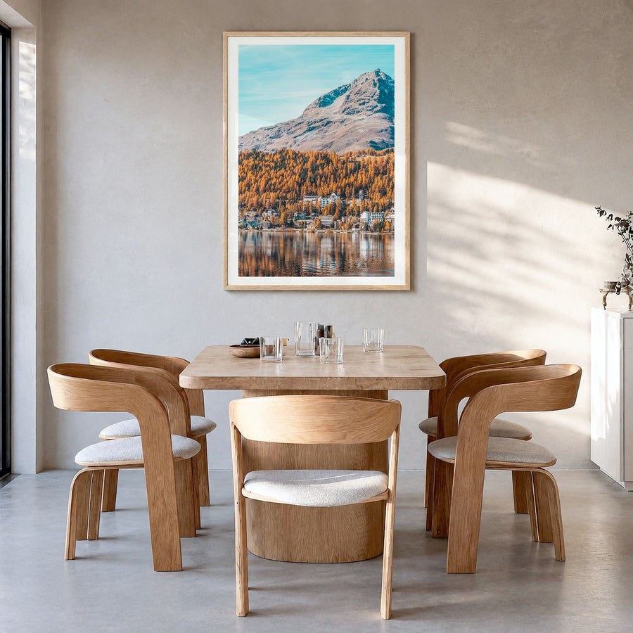 St. Moritz Photo Poster in a natural wood frame, hanging in a dining room, white border
