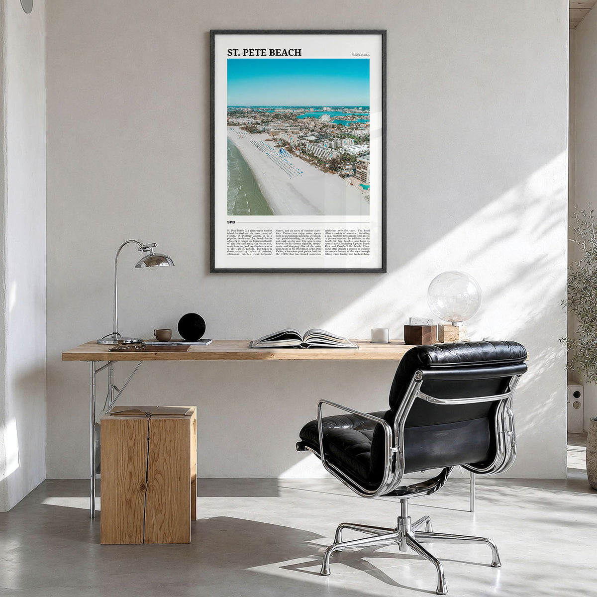 St. Pete Beach Travel Poster in a black wood frame, hanging in a bright home office