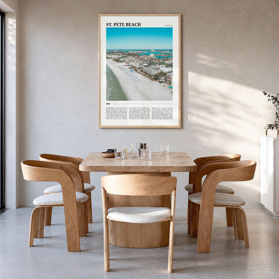 St. Pete Beach Travel Poster in a natural wood frame, hanging in a dining room