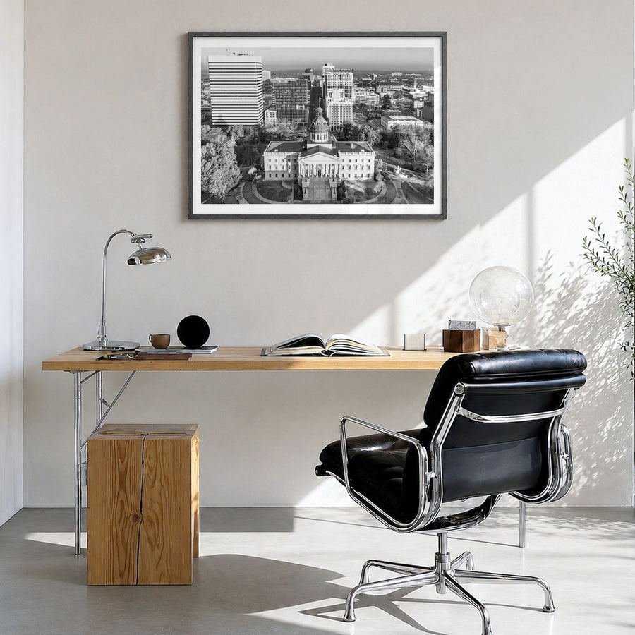 State College Photo Poster in a black wood frame, hanging in a bright home office, white border