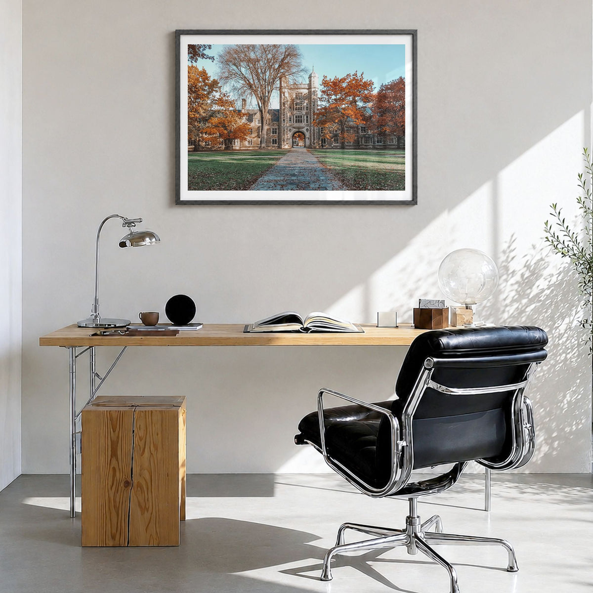 State College Photo Poster in a black wood frame, hanging in a bright home office, white border