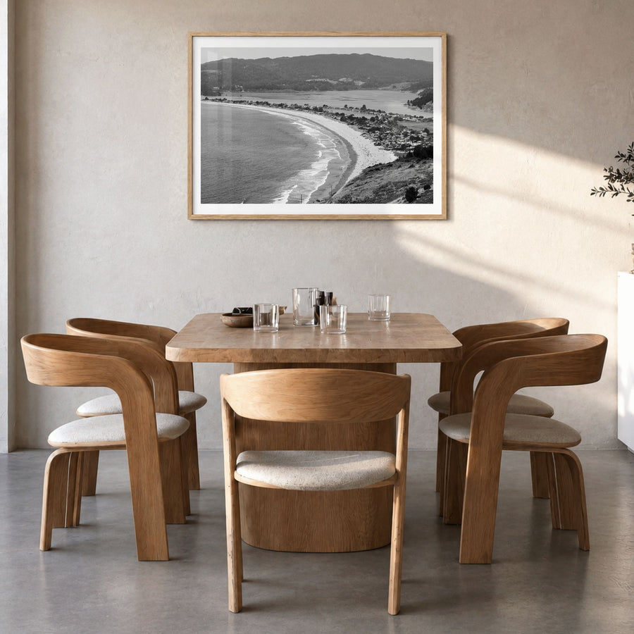 Stinson Beach Photo Poster in a natural wood frame, hanging in a dining room, white border