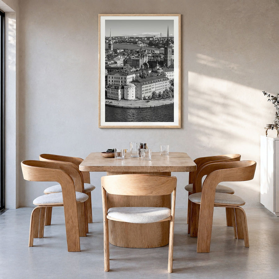 Stockholm Photo Poster in a natural wood frame, hanging in a dining room, white border