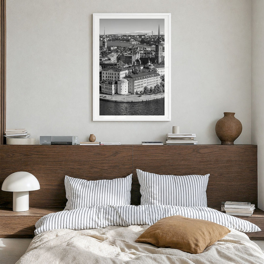 Stockholm Photo Poster in a white wood frame, hanging in a bedroom, white border