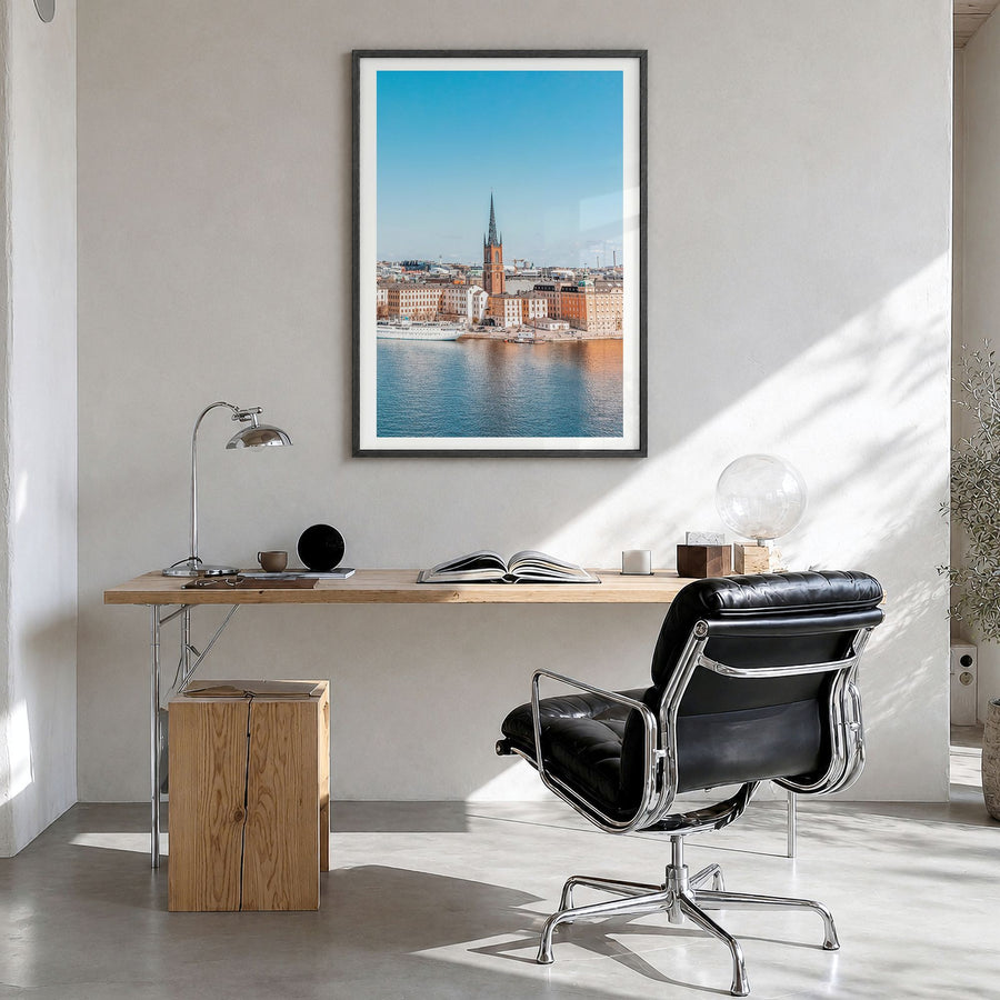 Stockholm Photo No 1 Poster in a black wood frame, hanging in a bright home office, white border