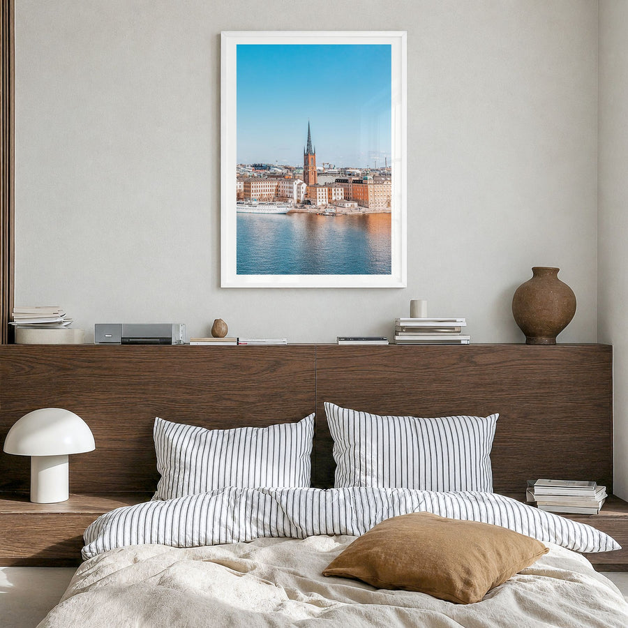 Stockholm Photo No 1 Poster in a white wood frame, hanging in a bedroom, white border