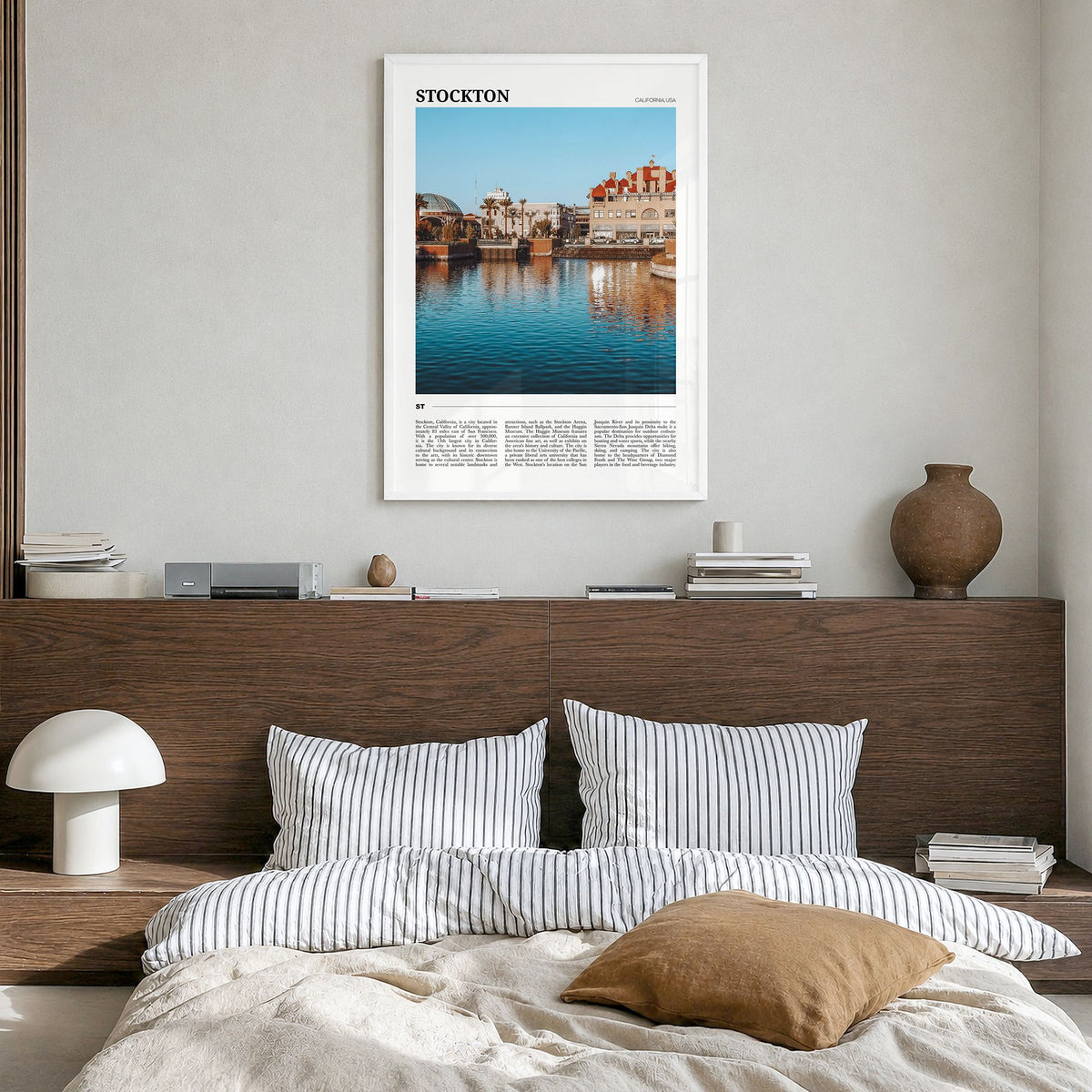 Stockton Travel Poster in a white wood frame, hanging in a bedroom