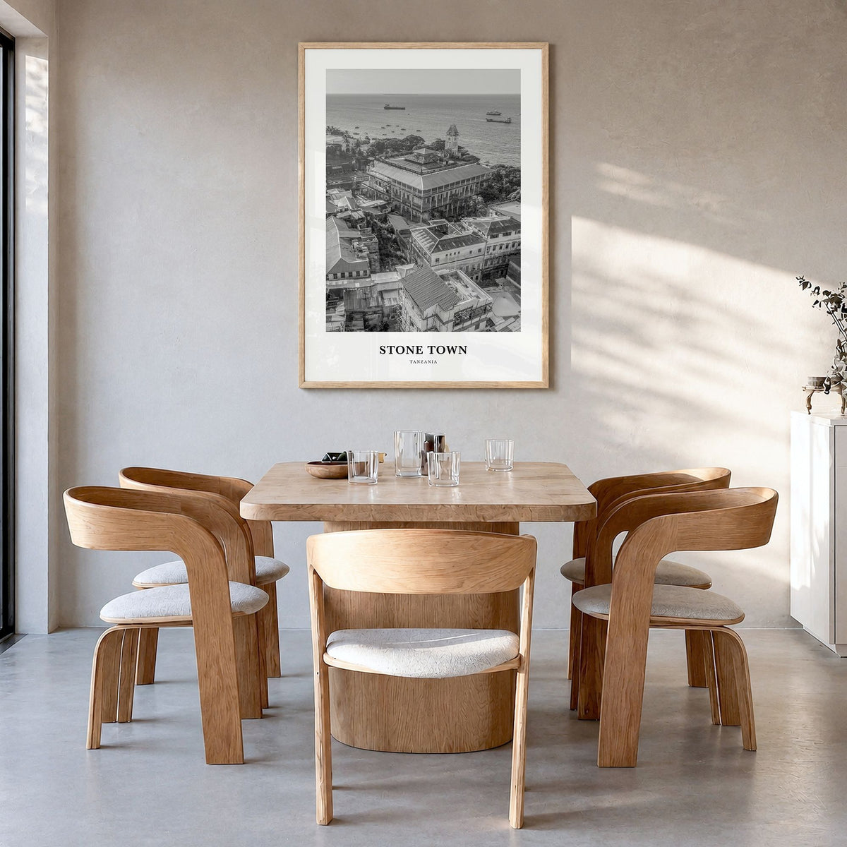 Stone Town Classic Poster in a natural wood frame, hanging in a dining room