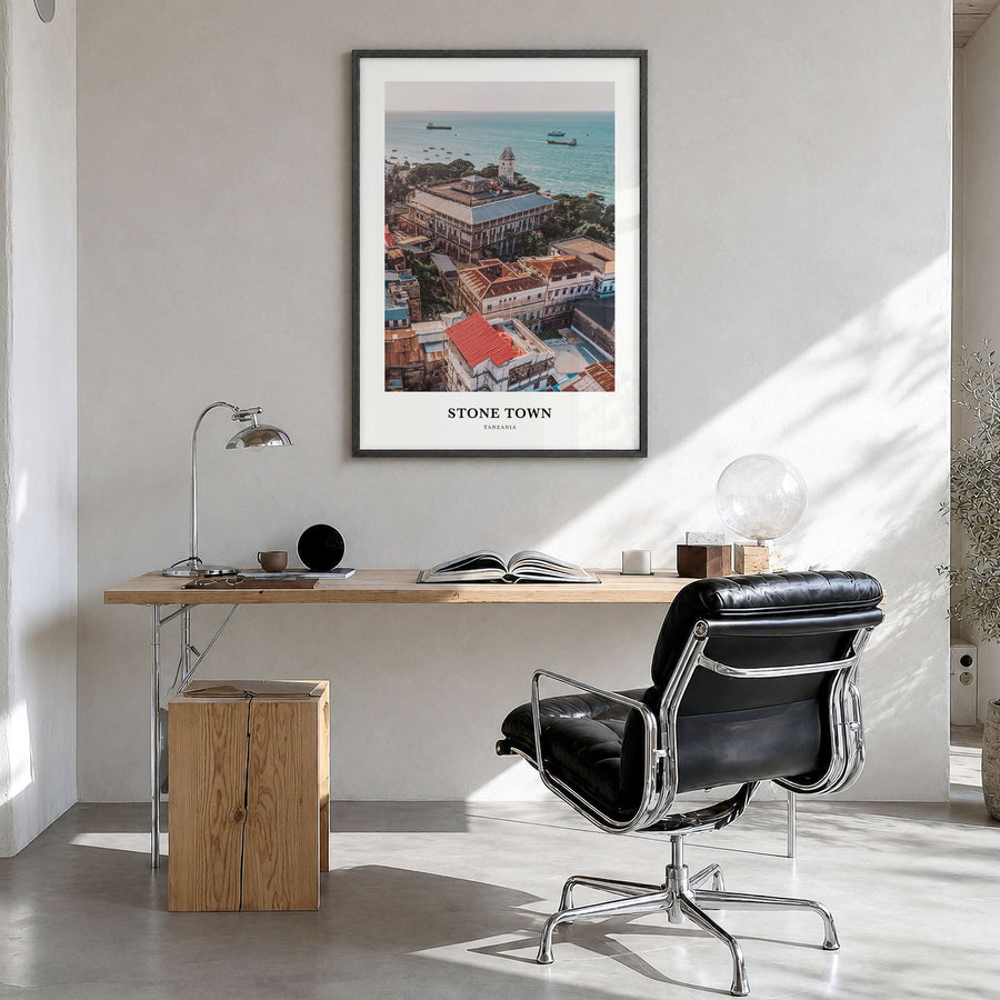 Stone Town Classic Poster in a black wood frame, hanging in a bright home office