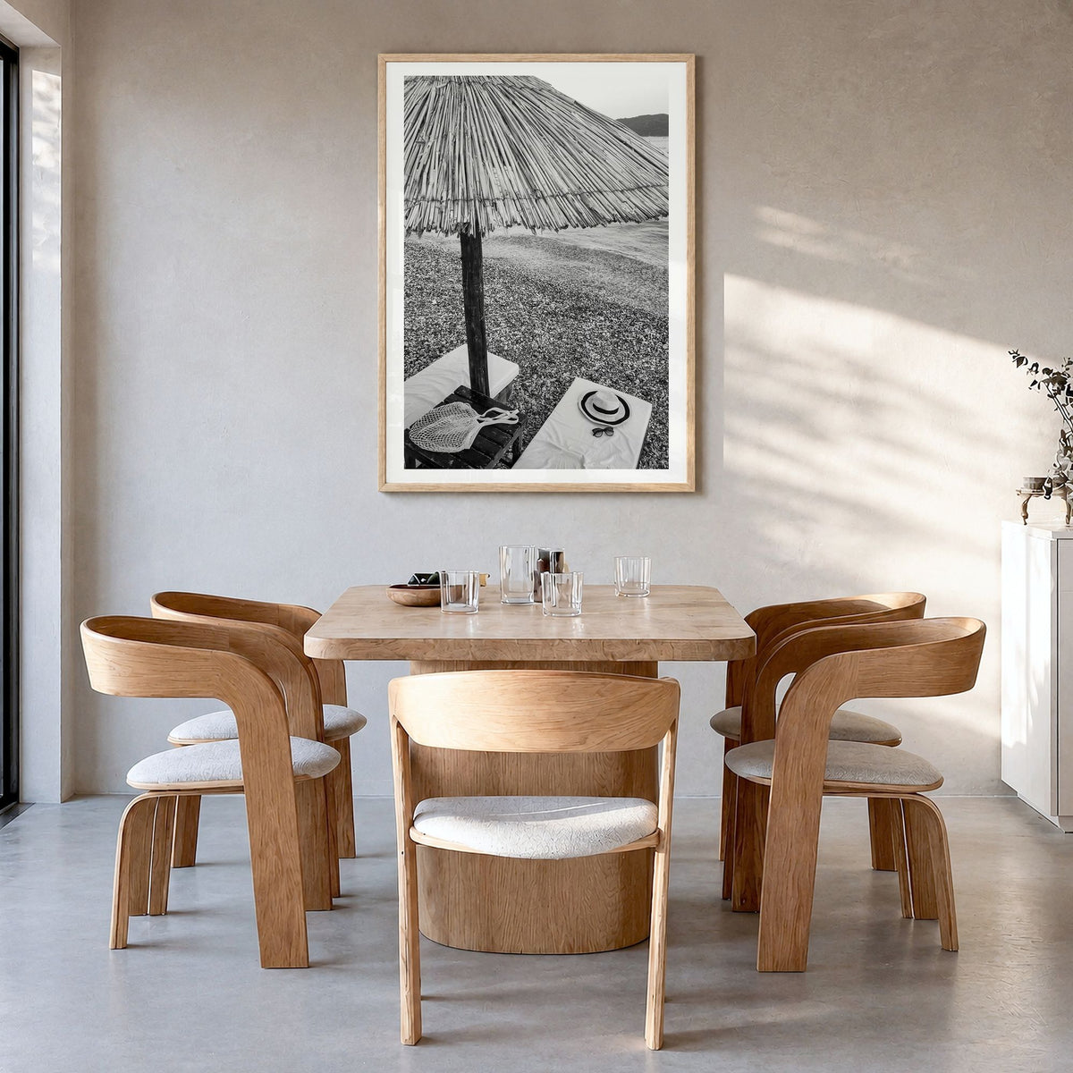 Straw Umbrella Photo Poster in a natural wood frame, hanging in a dining room, white border