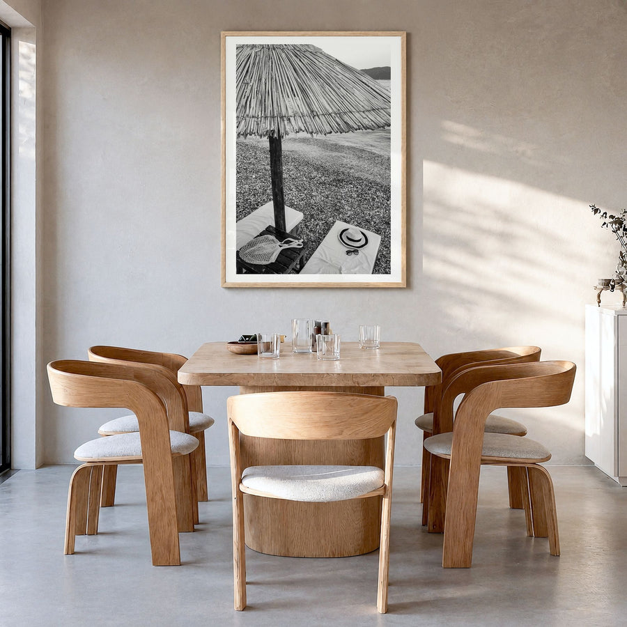 Straw Umbrella Photo Poster in a natural wood frame, hanging in a dining room, white border