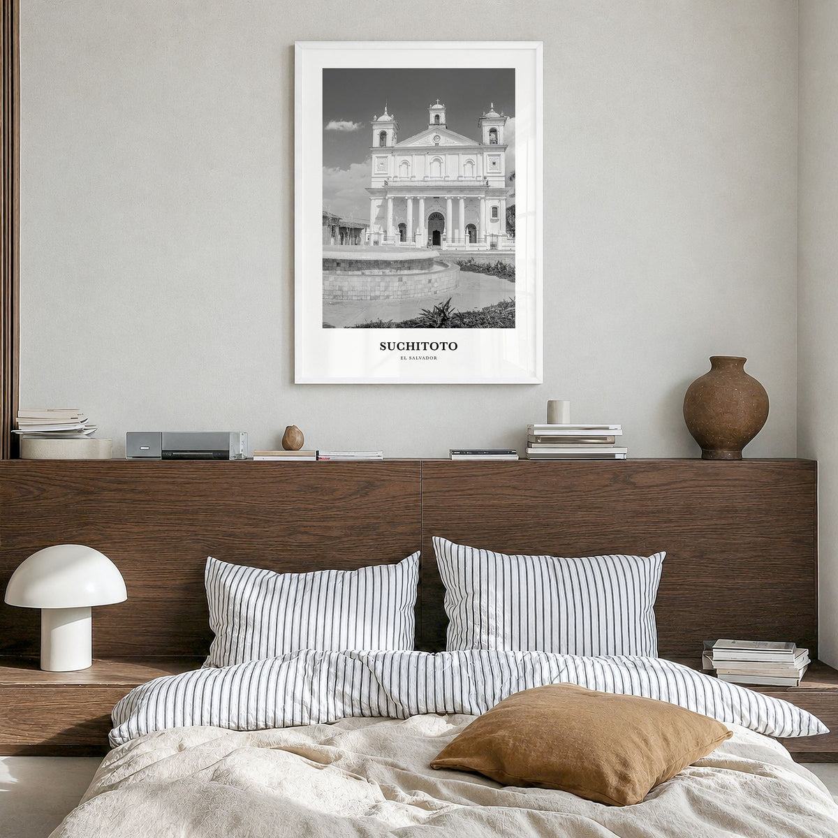 Suchitoto Classic Poster in a white wood frame, hanging in a bedroom