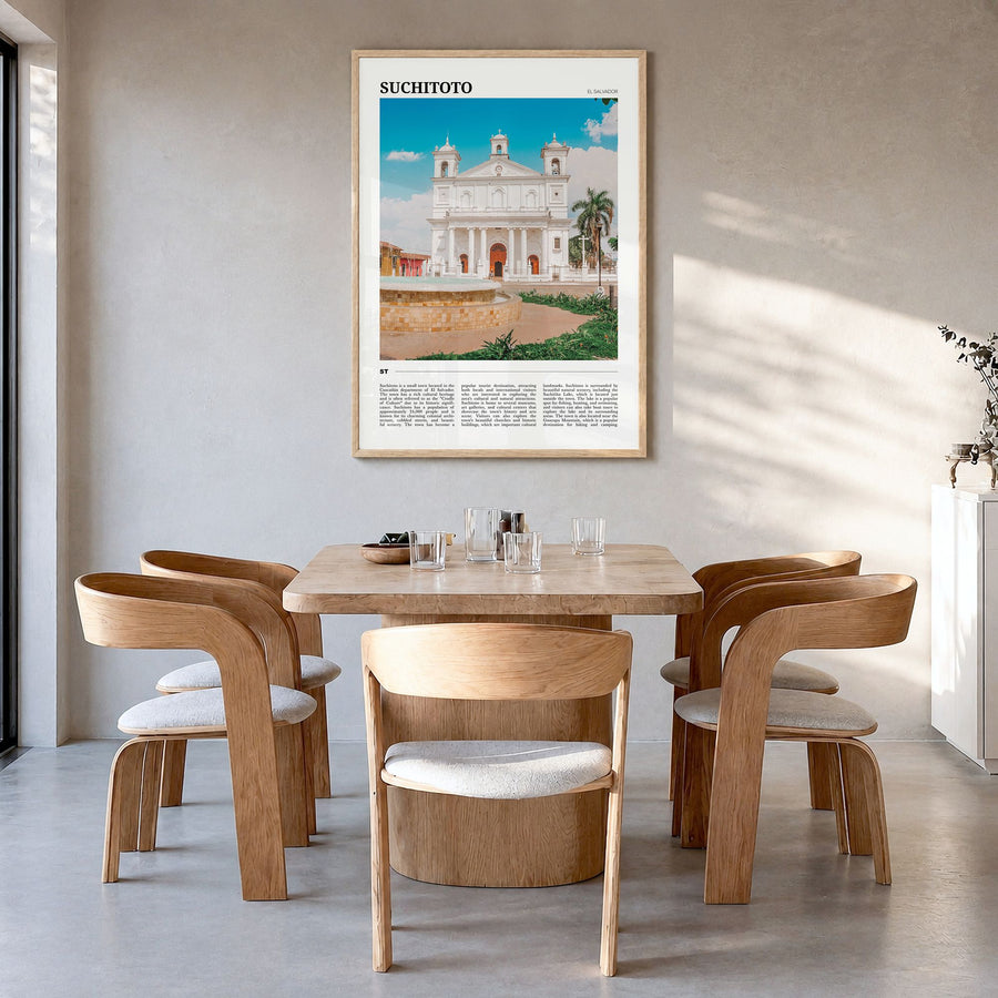 Suchitoto Travel Poster in a natural wood frame, hanging in a dining room