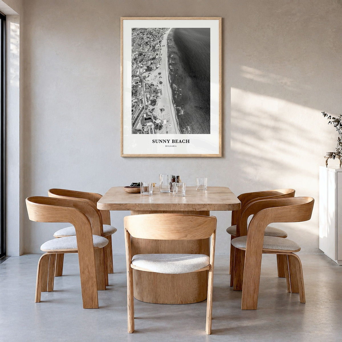 Sunny Beach Classic Poster in a natural wood frame, hanging in a dining room