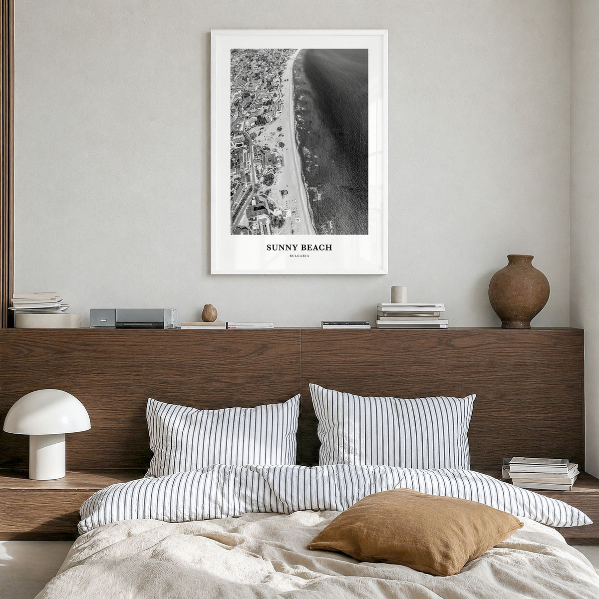 Sunny Beach Classic Poster in a white wood frame, hanging in a bedroom