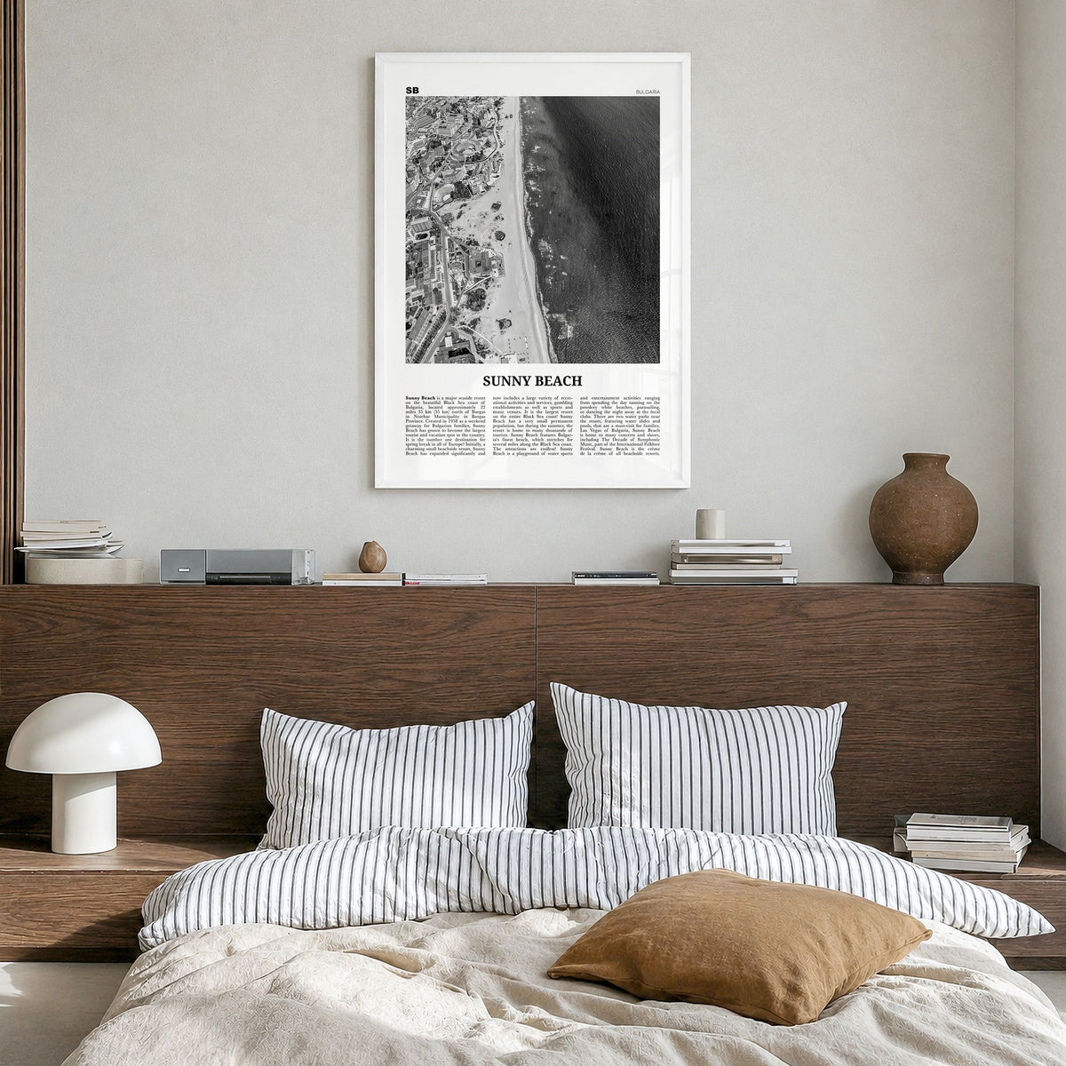 Sunny Beach Newspaper Poster in a white wood frame, hanging in a bedroom