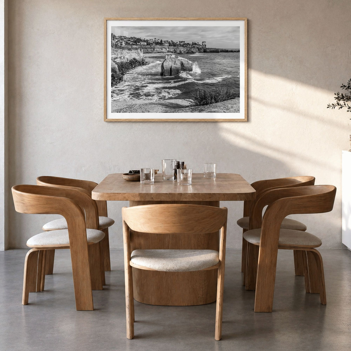 Sunset Cliffs Photo Poster in a natural wood frame, hanging in a dining room, white border