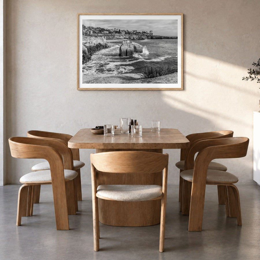 Sunset Cliffs Photo Poster in a natural wood frame, hanging in a dining room, white border