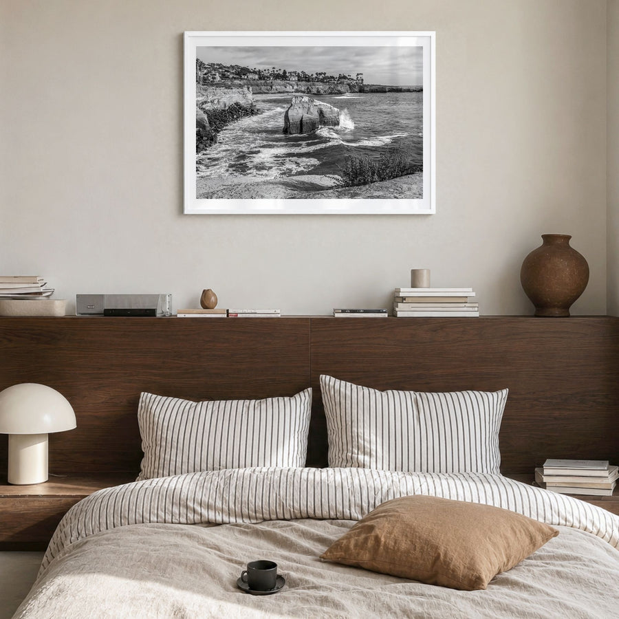 Sunset Cliffs Photo Poster in a white wood frame, hanging in a bedroom, white border