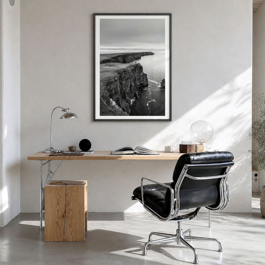 Sunset Cliffs Photo Poster in a black wood frame, hanging in a bright home office, white border
