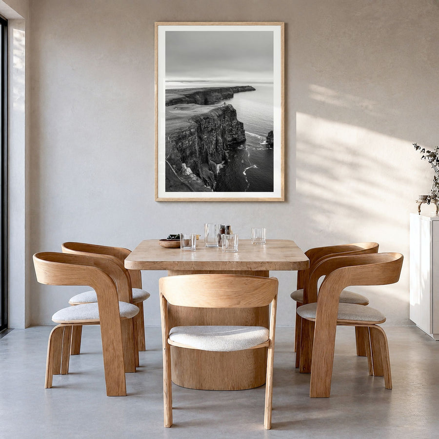 Sunset Cliffs Photo Poster in a natural wood frame, hanging in a dining room, white border
