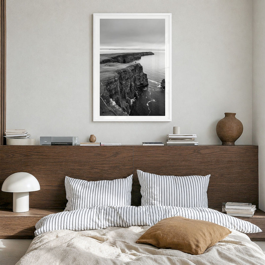 Sunset Cliffs Photo Poster in a white wood frame, hanging in a bedroom, white border