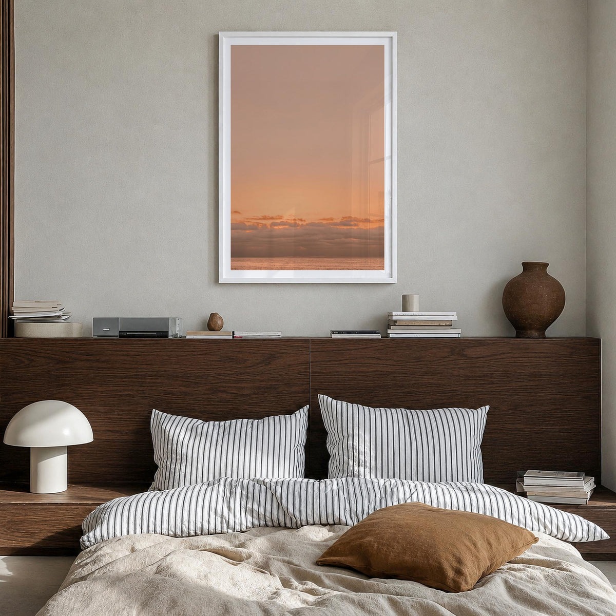 Sunset Ocean no. 1 colorful photo poster – vertical wall art in white wood frame with white border, hanging on wall