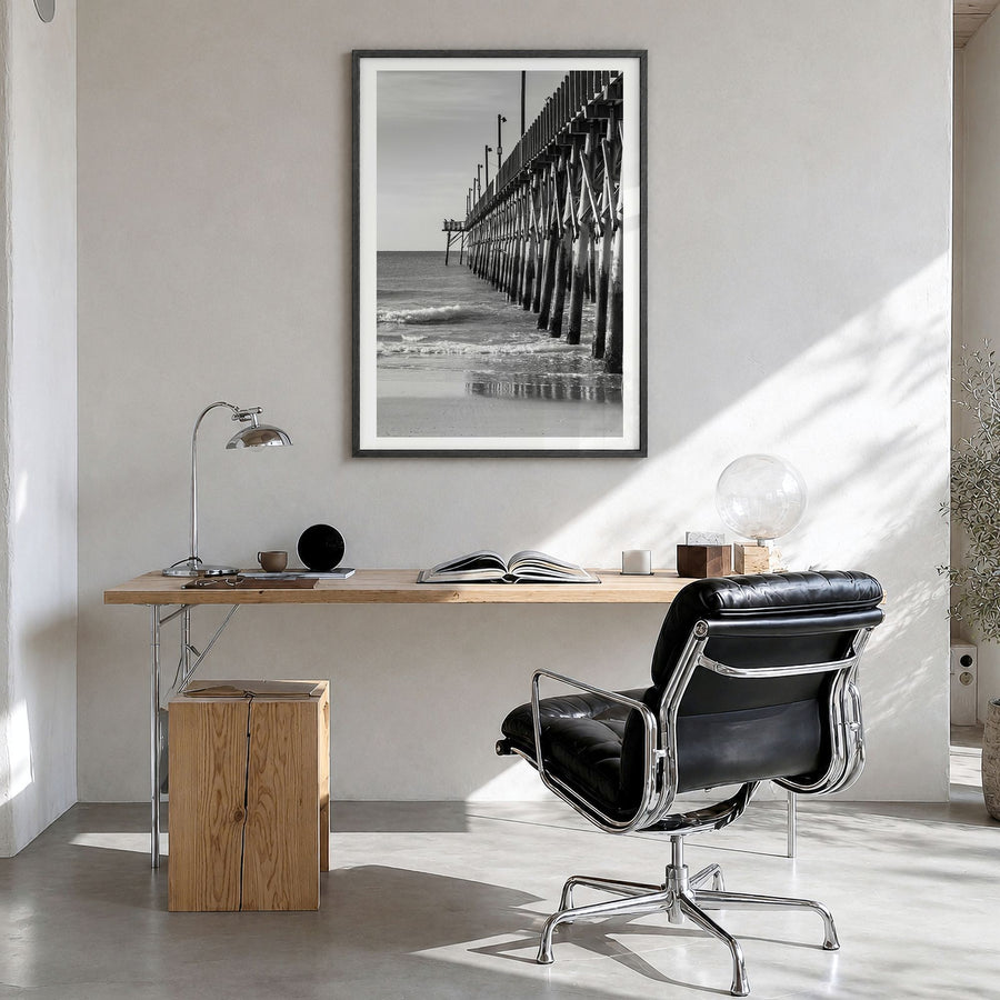 Surf City Photo Poster in a black wood frame, hanging in a bright home office, white border