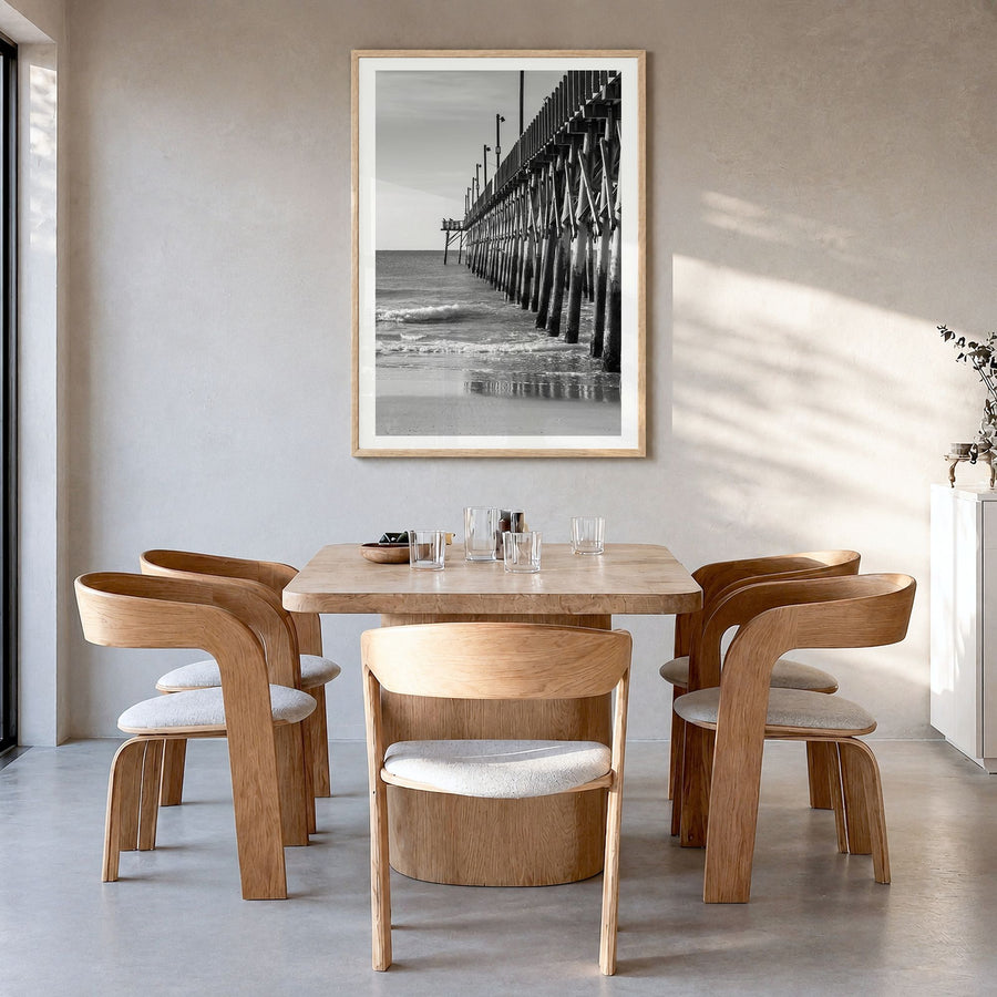 Surf City Photo Poster in a natural wood frame, hanging in a dining room, white border