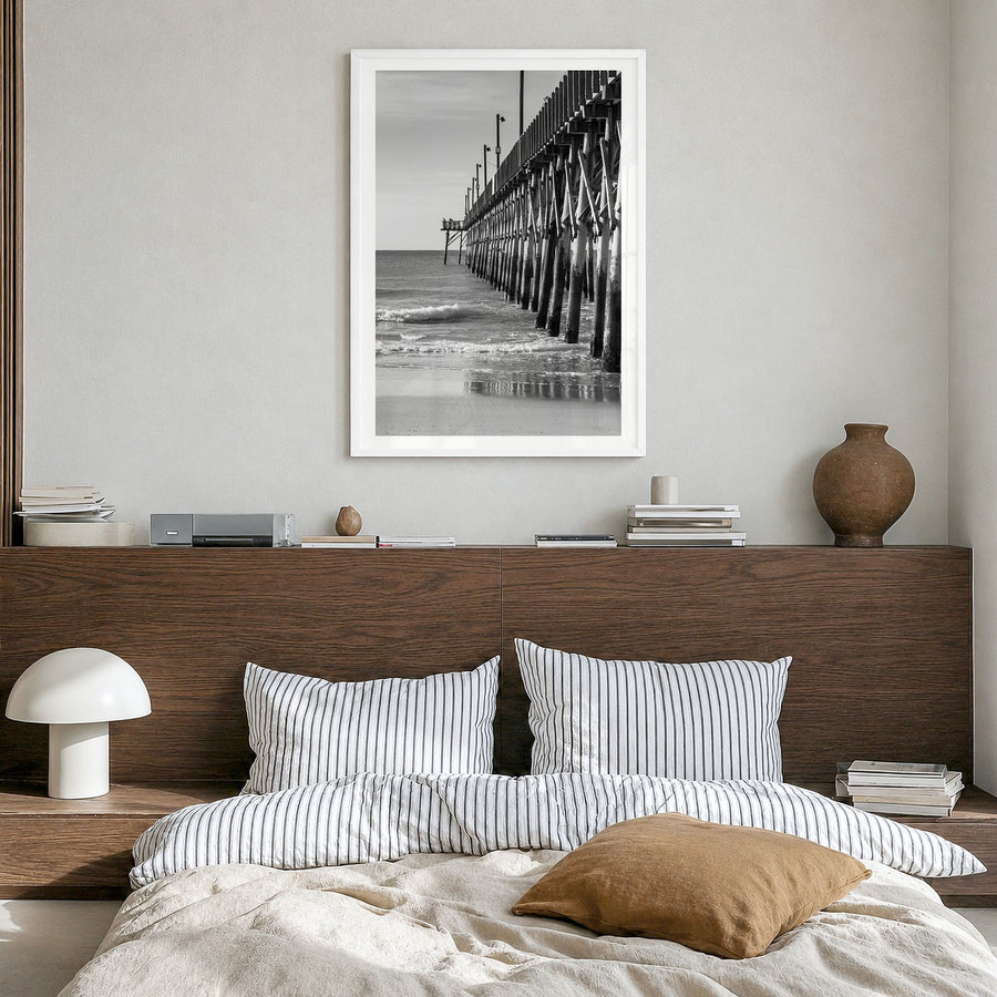 Surf City Photo Poster in a white wood frame, hanging in a bedroom, white border