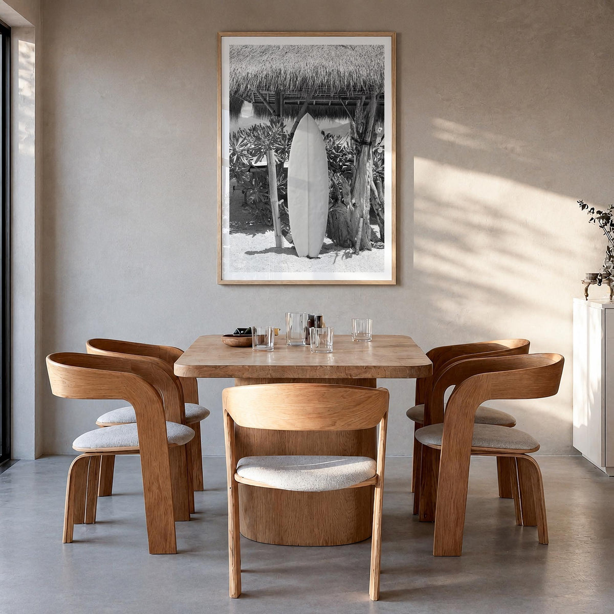 Surfboard no. 1 black & white photo poster – vertical wall art in natural wood frame with white border, hanging on wall