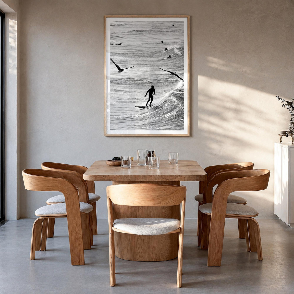 Surfing no. 1 black & white photo poster – vertical wall art in natural wood frame with white border, hanging on wall