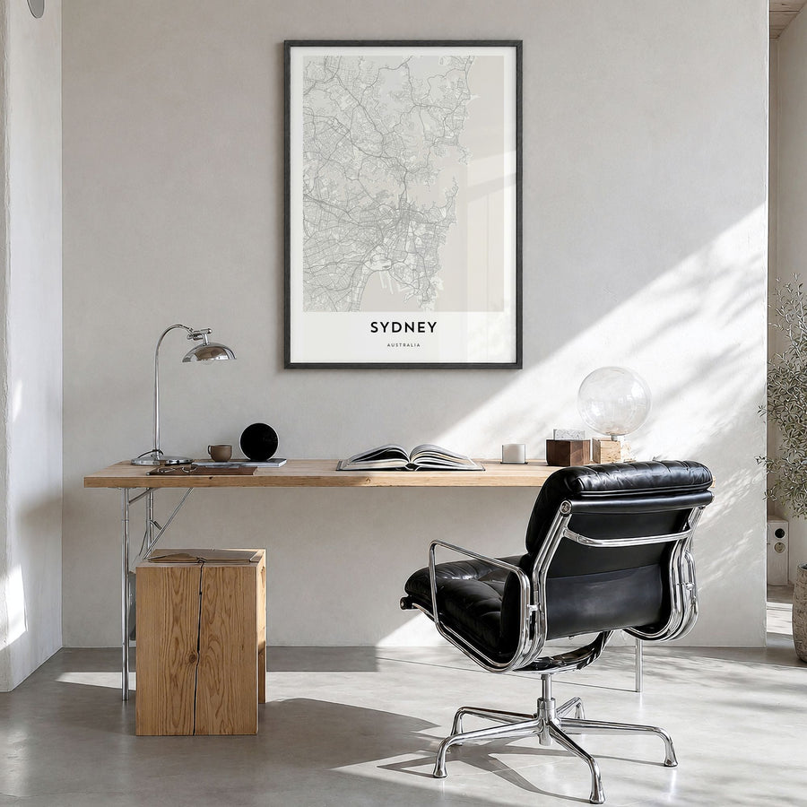 Sydney Map Poster in a black wood frame, hanging in a bright home office