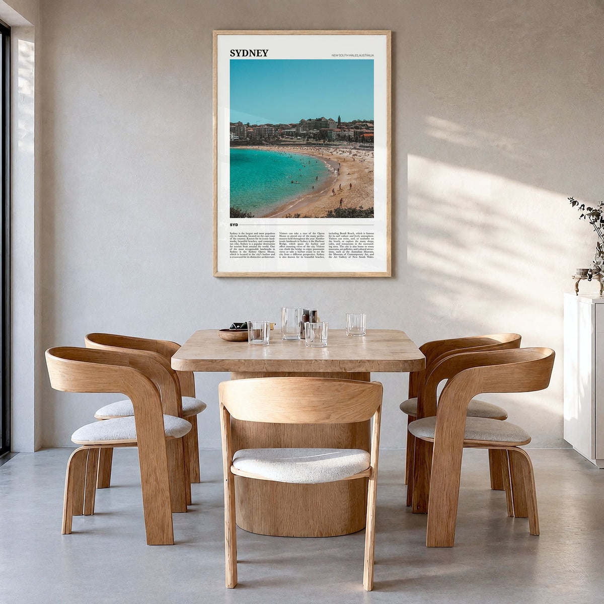 Sydney Travel Poster in a natural wood frame, hanging in a dining room