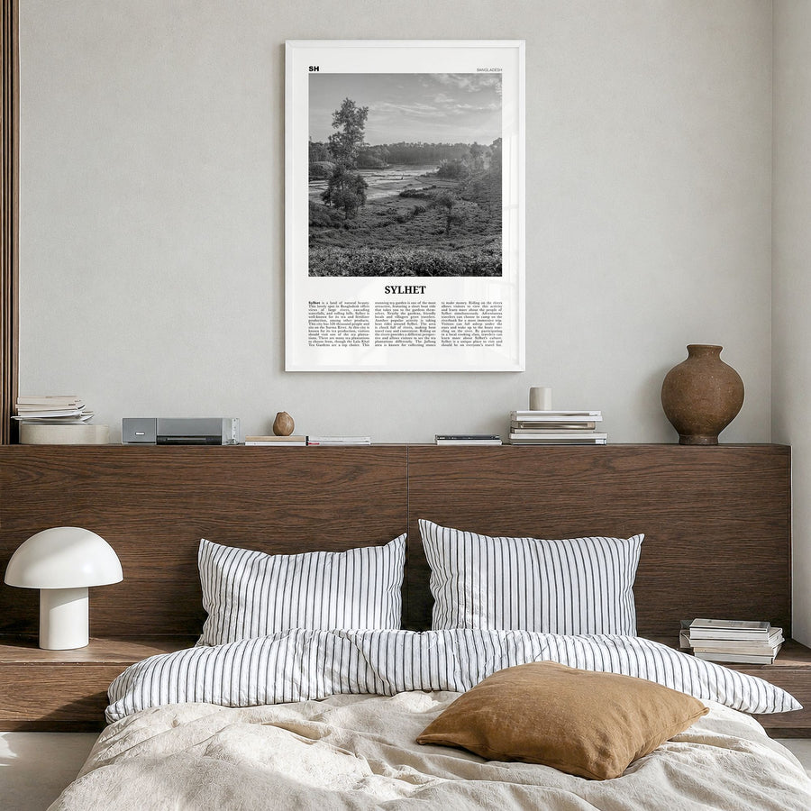 Sylhet Newspaper Poster in a white wood frame, hanging in a bedroom