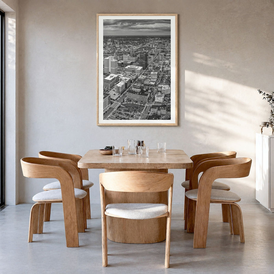Syracuse, New York Photo Poster in a natural wood frame, hanging in a dining room, white border