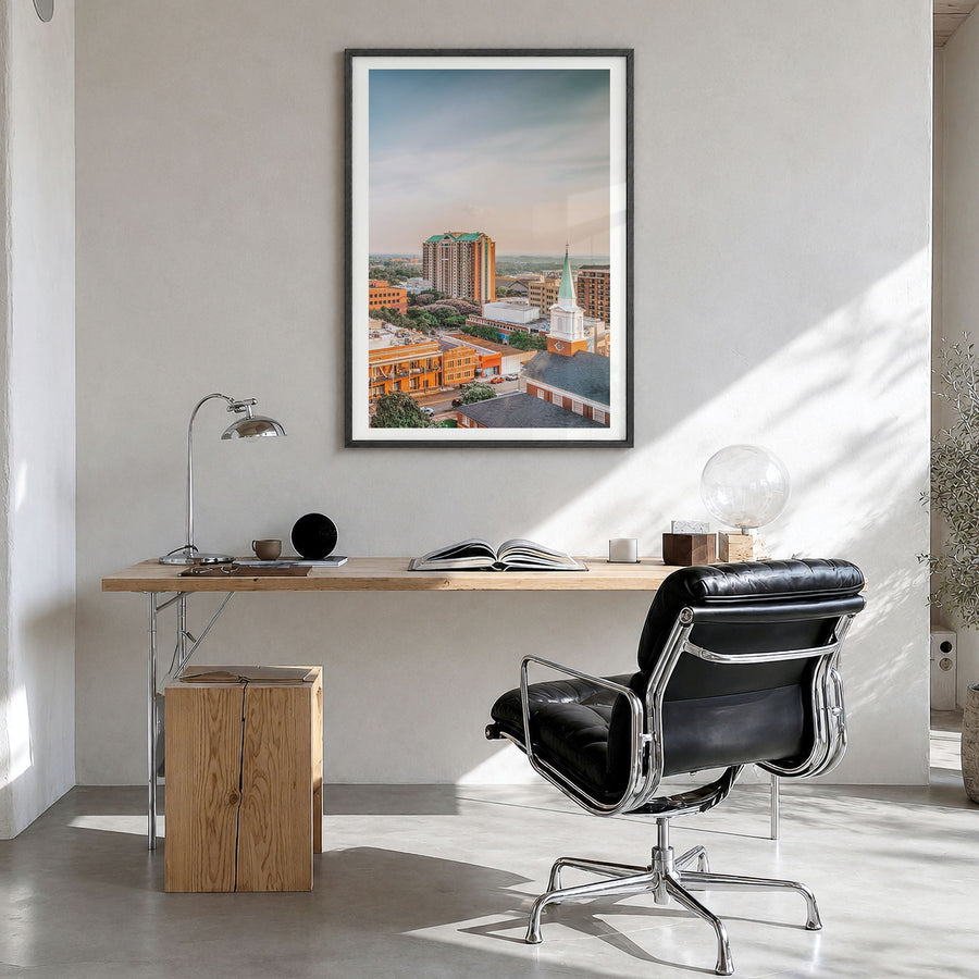 Tallahassee Photo Poster in a black wood frame, hanging in a bright home office, white border