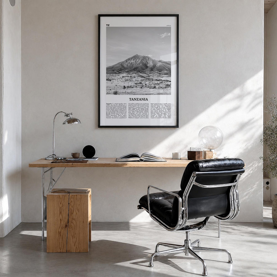 Tanzania black & white newspaper poster of Africa – vertical wall art in black wood frame, hanging on wall