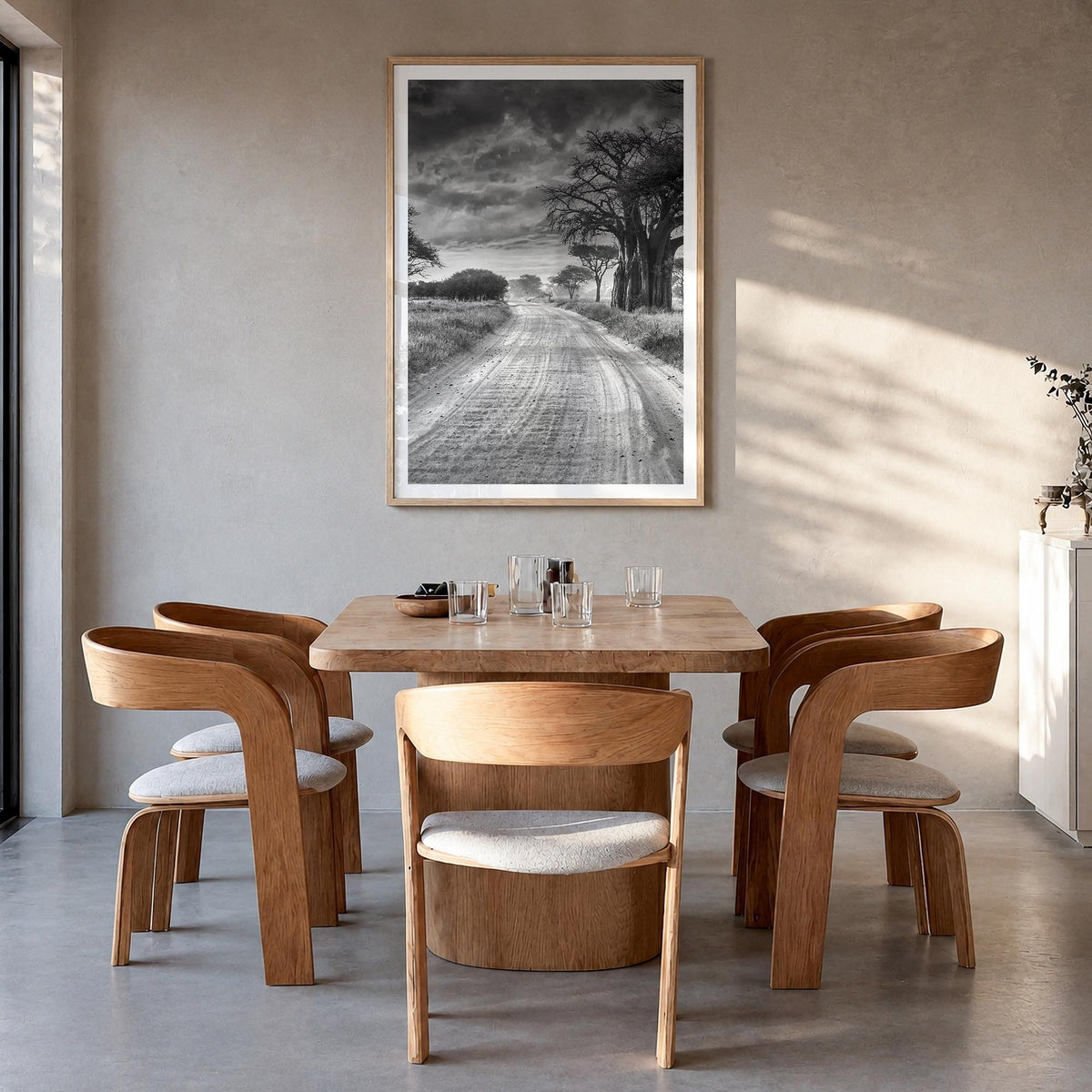 Tanzania black & white photo poster of Africa – vertical wall art in natural wood frame with white border, hanging on wall