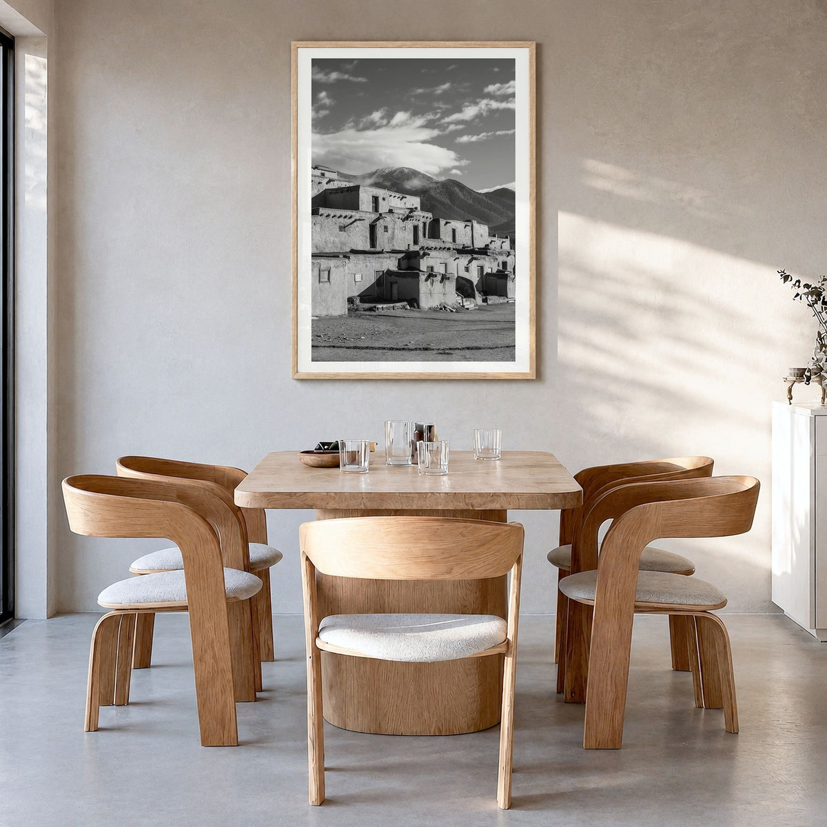 Taos Photo Poster in a natural wood frame, hanging in a dining room, white border