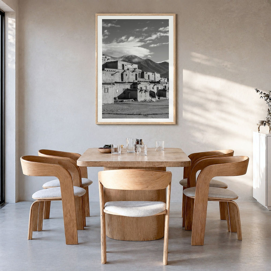 Taos Photo Poster in a natural wood frame, hanging in a dining room, white border