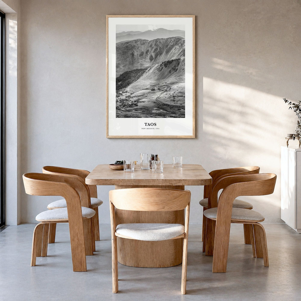 Taos Classic Poster in a natural wood frame, hanging in a dining room