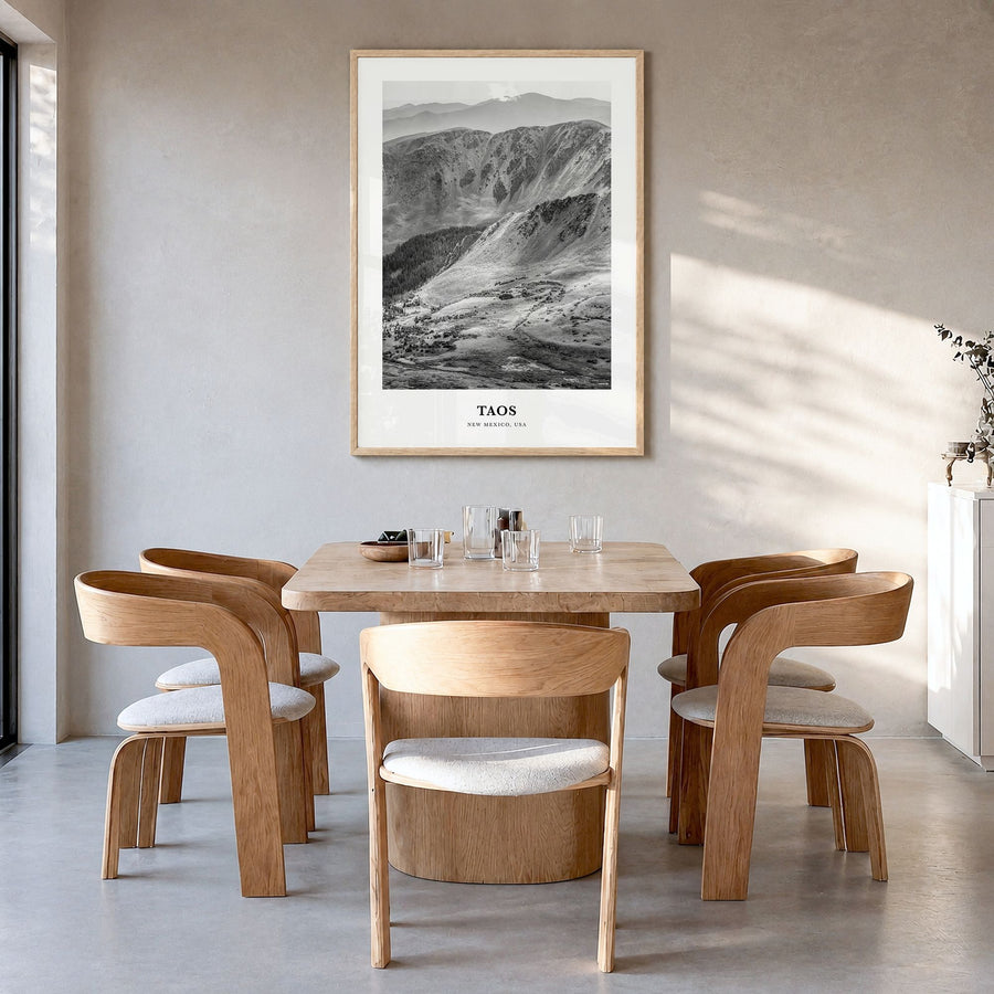 Taos Classic Poster in a natural wood frame, hanging in a dining room