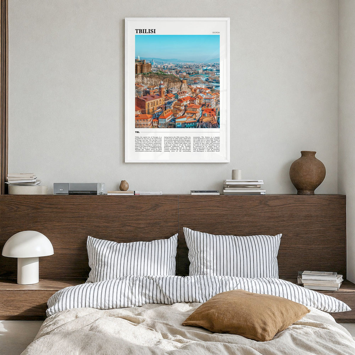 Tbilisi Travel Poster in a white wood frame, hanging in a bedroom