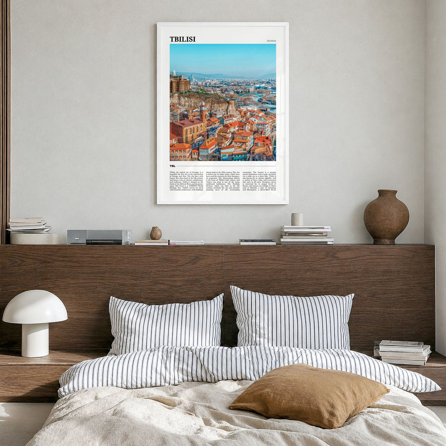 Tbilisi Travel Poster in a white wood frame, hanging in a bedroom
