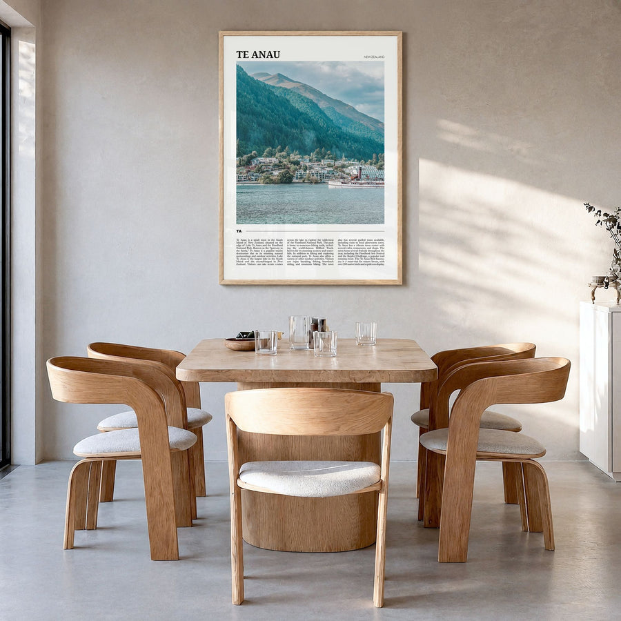 Te Anau Travel Poster in a natural wood frame, hanging in a dining room