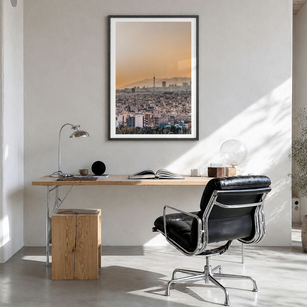Tehran Photo Poster in a black wood frame, hanging in a bright home office, white border