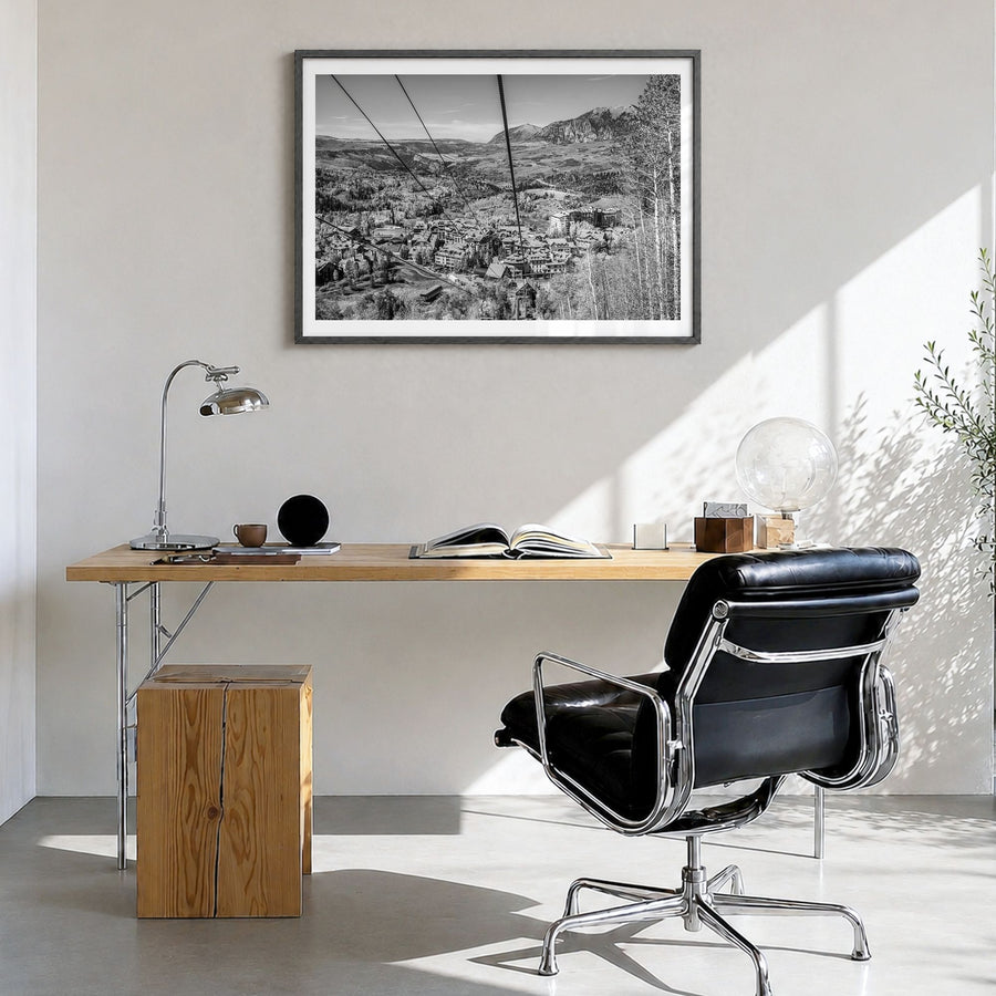 Telluride Photo Poster in a black wood frame, hanging in a bright home office, white border