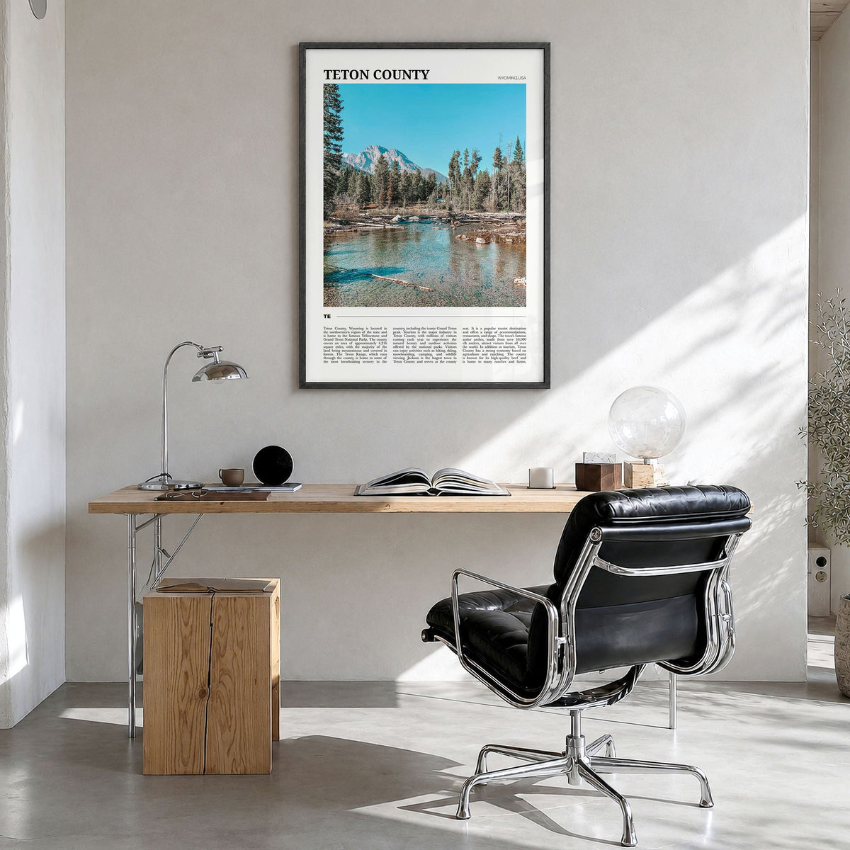 Teton County Travel Poster in a black wood frame, hanging in a bright home office