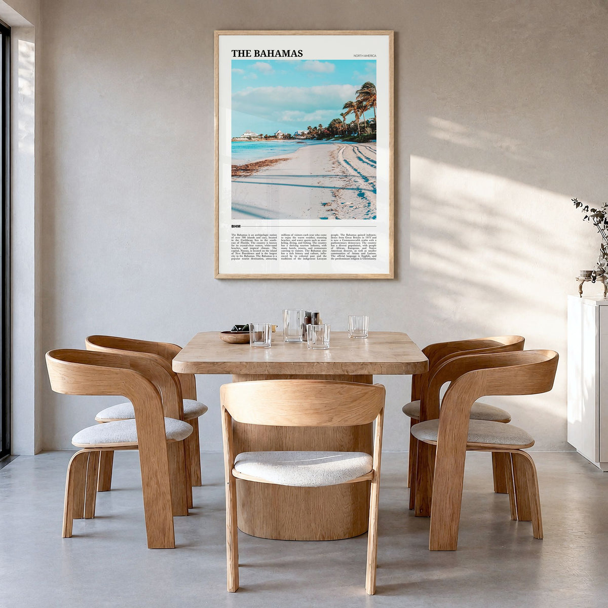 The Bahamas Travel Poster in a natural wood frame, hanging in a dining room